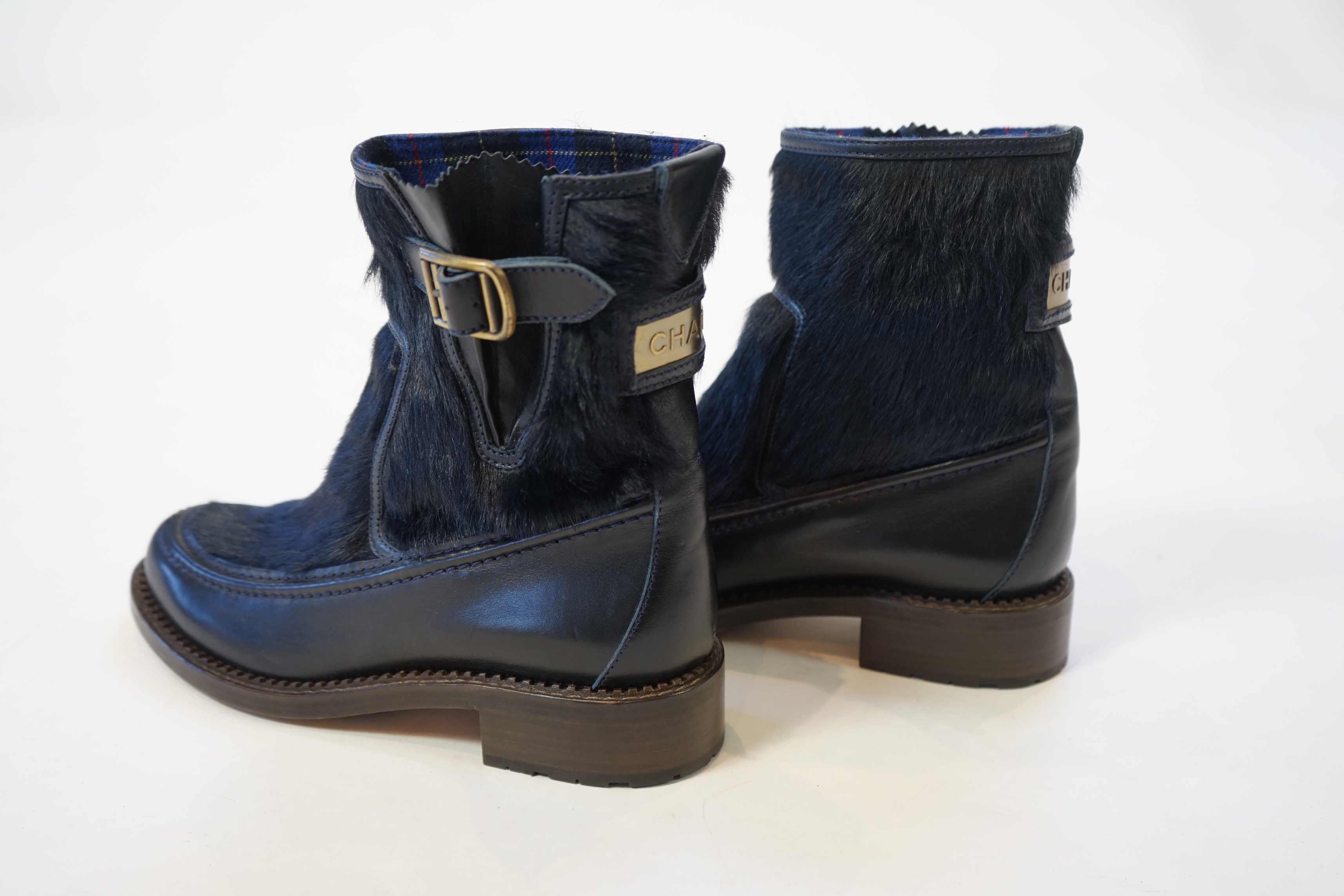 A pair of Chanel lady's navy blue leather calf hair pleated belted buckle boots, size EU 40.5